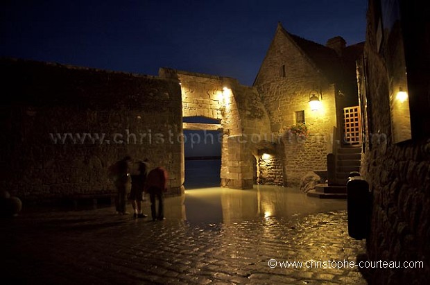 Main Gate of the Mont-Saint-Michel, Flooded by the High Tide, at night.
